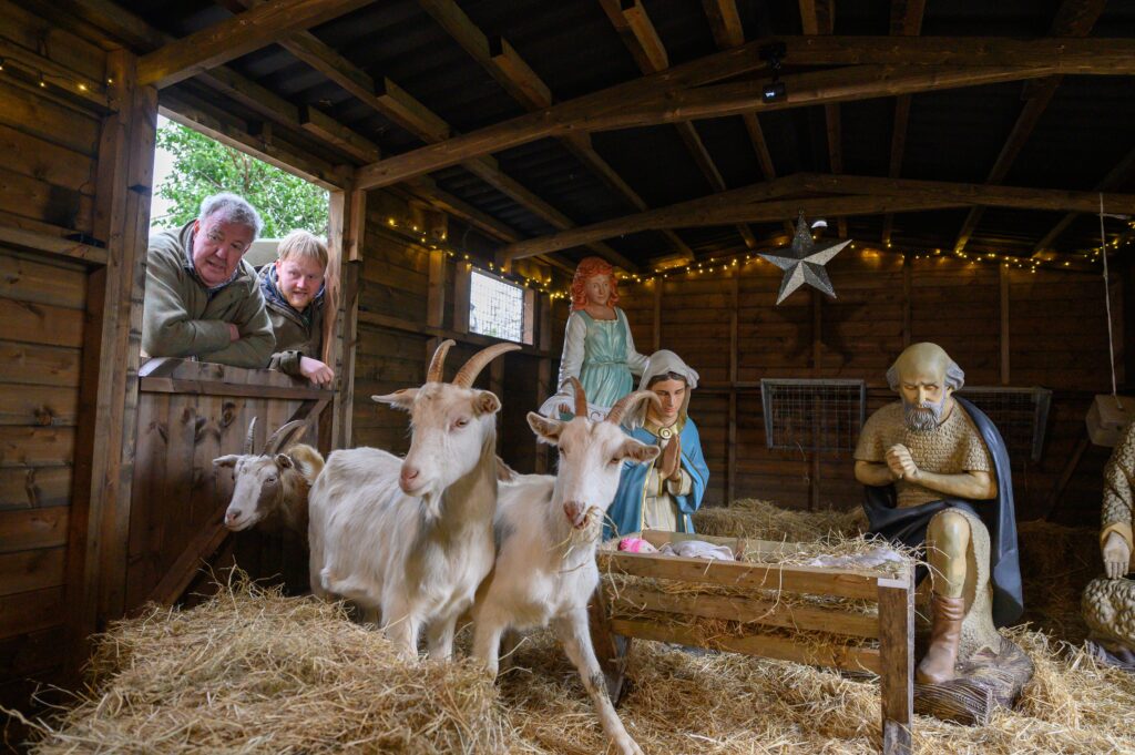 Jeremy Clarkson and Kaleb Cooper looking inside a shed with goats.