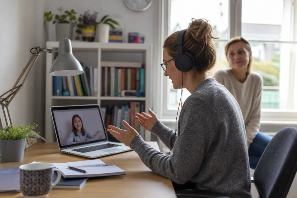Online tutor preparing a lesson on a laptop in a UK home office